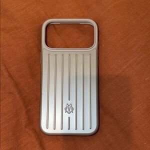 RIMOWA iPhone 17 Pro Max Silver Phone Case with Raised Stripe Design